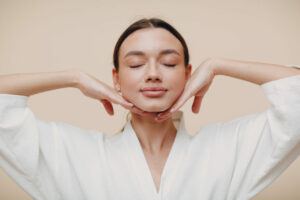 young,woman,doing,face,building,yoga,facial,gymnastics,self,massage