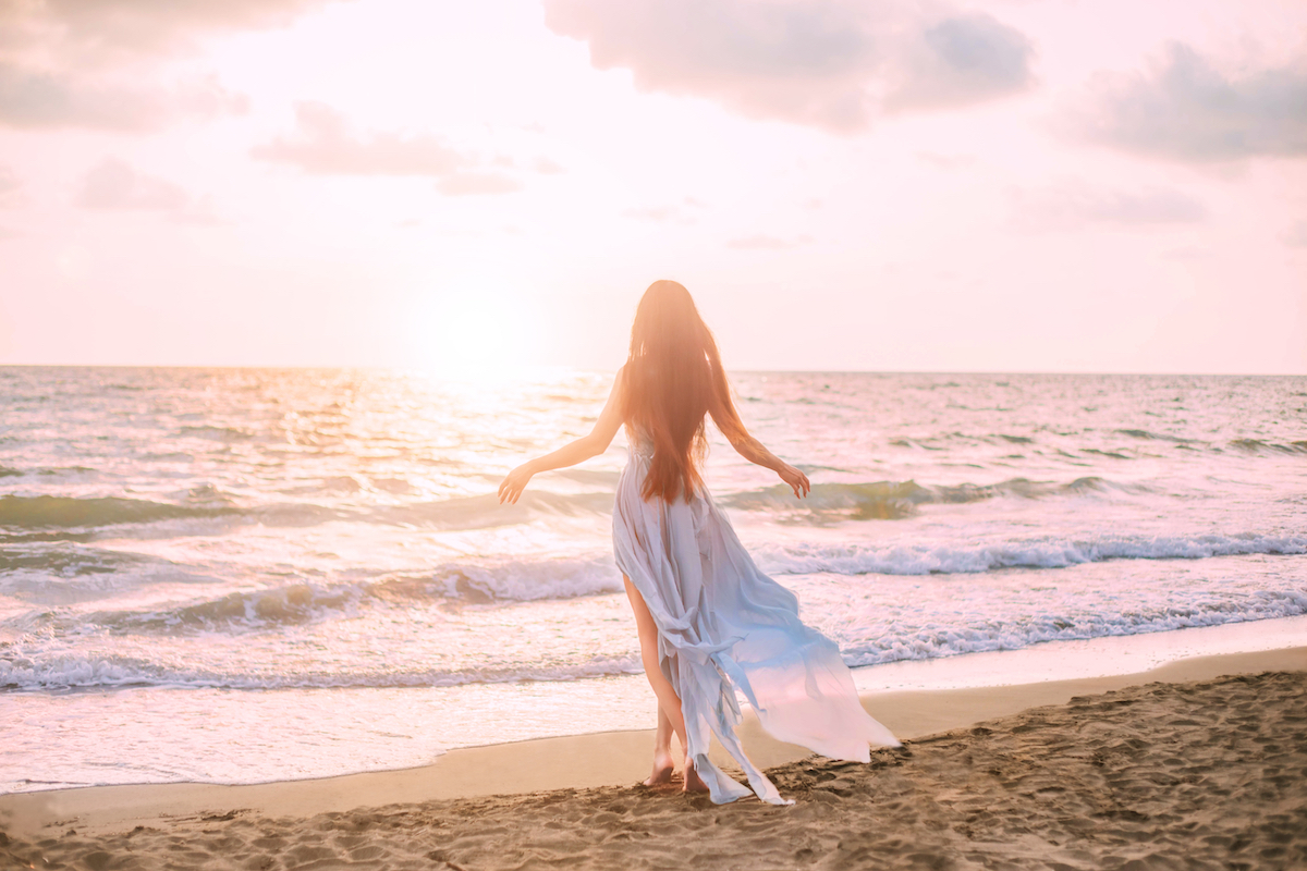 happy,mysterious,woman,silhouette,mermaid,long,black,hair,walks,beach