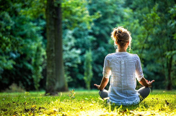 woman meditating outdoors