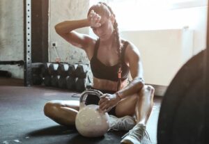 young fit woman exercise with kettle ball getting tired picture id1165279566 copy
