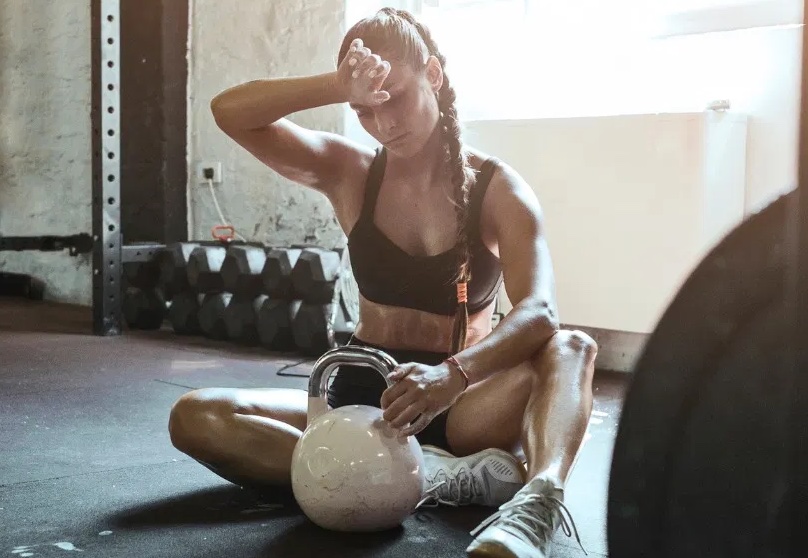 young fit woman exercise with kettle ball getting tired picture id1165279566 copy